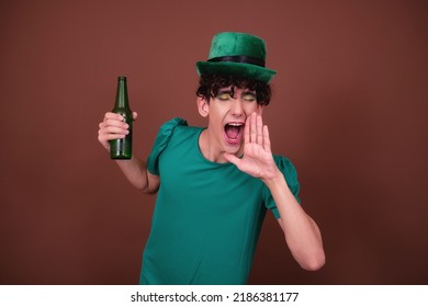 A Guy Dressed As A Drag Queen Drinks Beer. St.Patrick 's Day.