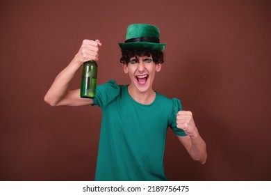 A Guy Dressed As A Drag Queen Drinks Beer. St.Patrick 's Day.