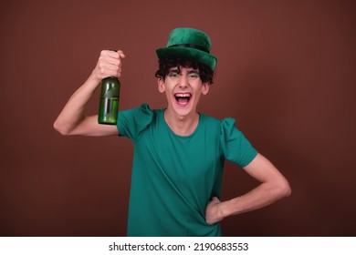 A Guy Dressed As A Drag Queen Drinks Beer. St.Patrick 's Day.