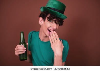 A Guy Dressed As A Drag Queen Drinks Beer. St.Patrick 's Day.