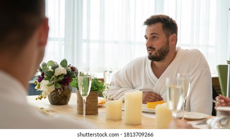 A Guy In A Dressing Gown Is Resting And Chatting