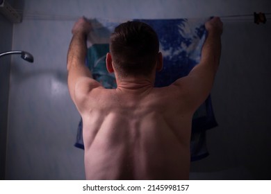 The Guy Dries A Towel In The Bathroom. Young Man With A Bare Back. Body Cleanliness. Tall Man Doing Household Chores. The Husband Does The Laundry.