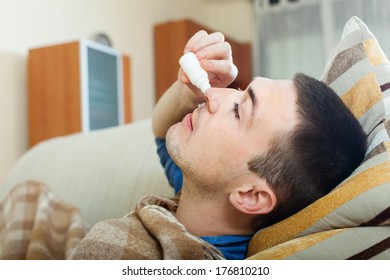 Guy Dripping Nasal Drops In Home