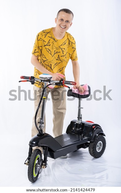 guy in an\
electric car. man in the studio on a tricycle. White background.\
electric scooter\
maintenance