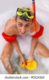 Guy Is Enjoying A Bath In Mask With Snorkel. Playing With His Rubber Ducky.