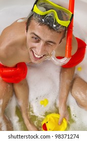 Guy Is Enjoying A Bath In Mask With Snorkel. Playing With His Rubber Ducky.