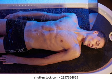 guy enjoys charcot shower massage reception in beautiful spa salon, spa salon concept

