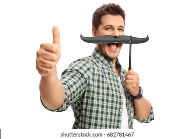 Guy With Fake Moustache Making A Thumb Up Gesture Isolated On White Background