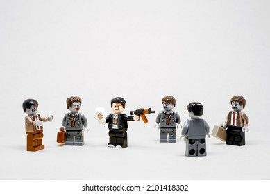 Guy fighting zombies in the office. Business concept. Illustrative editorial. January 02, 2022 - Shutterstock ID 2101418302
