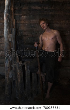 guy with the fork in an old rustic barn