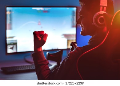 The Guy Gamer With Headset Playing Video Games On His Personal Computer