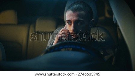 Guy Gets in Car Irritated While Continuing Unpleasant Phone Conversation on Smartphone. Sitting Behind Wheel, Speaks With Frustration. Work Stress, Emotional Tension, and Difficult Communication.