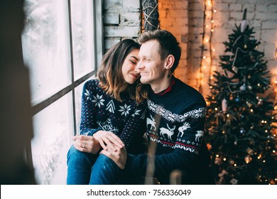 A Guy With A Girl Is Celebrating Christmas. A Loving Couple Enjoy Each Other On New Year's Eve. New Year's Love Story