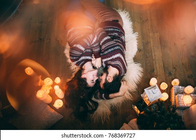 A guy with a girl is celebrating Christmas. A loving couple enjoys each other on New Year's Eve in a cozy home environment. New Year's love story.
 - Powered by Shutterstock