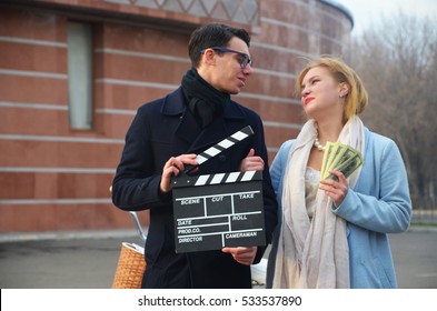 Guy and girl with clapperboard
