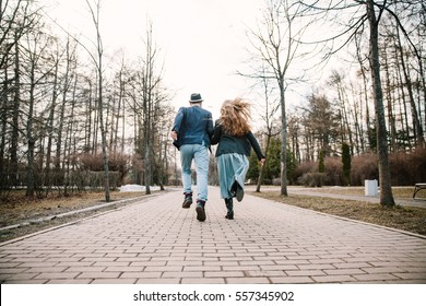 Guy And Girl Run Away On The Road