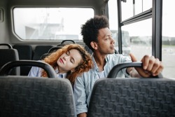 Guy With A Girl Sitting Together On The Bus After School. The Girl Who Had Fallen Asleep On The Bus Leaned On The Passenger's Shoulder