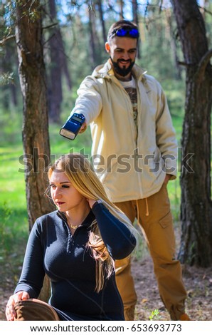 the guy with the girl walking in the woods, they are very fun. the guy with the beard , the girl is a tall blonde with curvaceous .