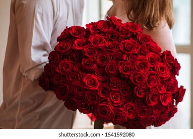 the guy gives the girl a big bouquet of roses, a marriage proposal