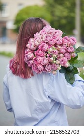 The Guy Gives The Girl Flowers On The Street, Vertical Photo 