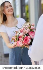 The Guy Gives The Girl Flowers On The Street, Vertical Photo 