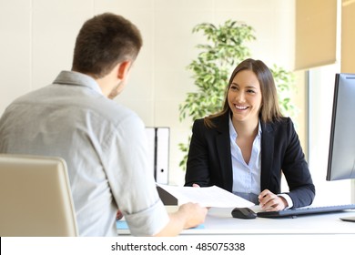 Guy giving a curriculum vitae to his interviewer in a job interview