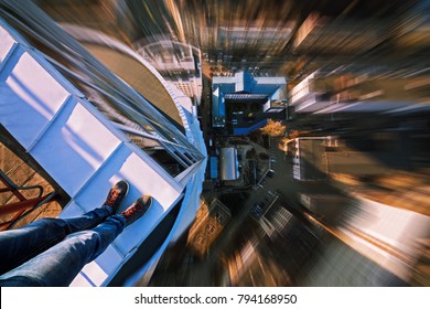The guy is going to commit suicide. At the edge of the roof. Fall from the skyscraper.