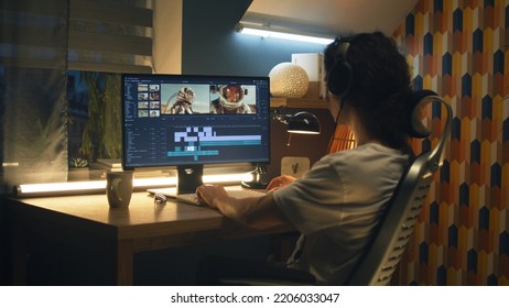 Guy in headphones editing video with astronauts for space blog in professional program while working remotely on computer at home - Shutterstock ID 2206033047
