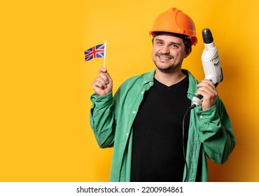 Guy In Helmet With Drill And GB Flag On Yellow Background