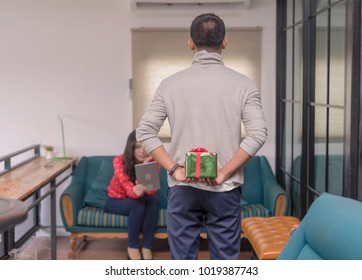 Guy Is Holding Gift Behind Him Is Trying To Surprise His Is Waiting Girlfriend At Home.