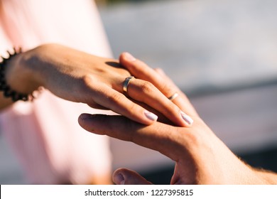 Guy holds girl's hand