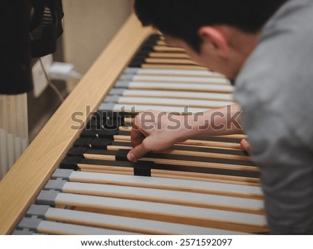 The guy inserts the frame slats into the plastic mount.