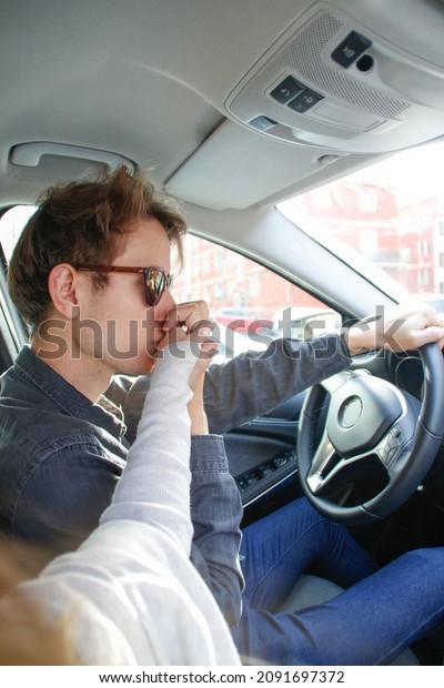 guy kissing his\
partner\'s hand while\
driving