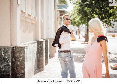 Guy Looking At A Nice Girl Passing By...while Walking At The Street