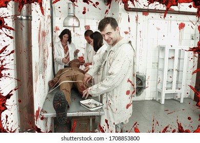 Guy with mad look standing over zombie mannequin with friends in quest room styled as abandoned surgical room with blood traces