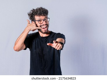 Guy Making Call Sign With Hand, Smiling Handsome Man Pointing To The Front, Man Making Phone Call Sign, Man With Call Sign