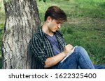 The guy with the notebook in the park