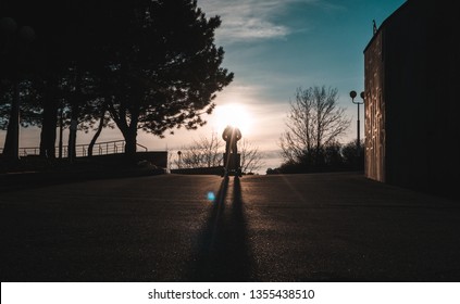 guy on a hoverboard at sunset