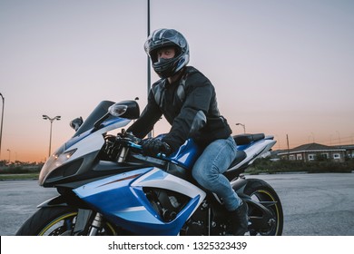 A Guy On A Motorcycle Is Going At A Speed On The Road. Helmet, Road, Motorcycle, Sunset, Romance, Spring.