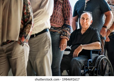 A Guy On Wheelchair In A Queue