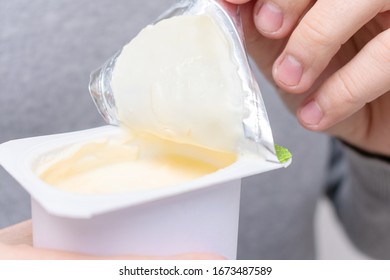 Guy Opens A Jar Of Yogurt, Closeup