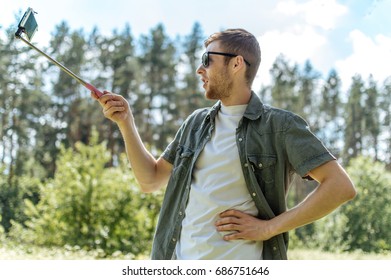 The Guy Is Photographed By A Selfie Stick