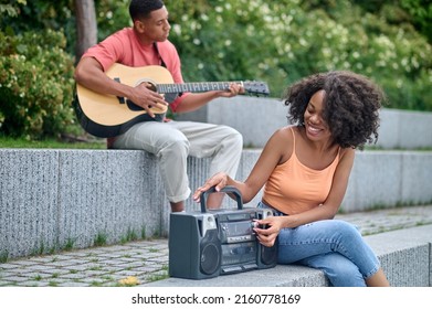 Guy Playing Guitar Girl With Tape Recorder