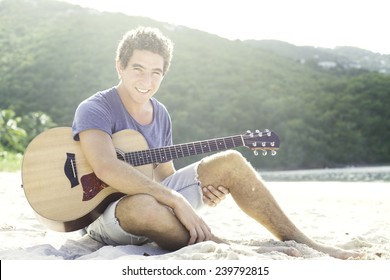 Guy Playing Guitar On The Beach