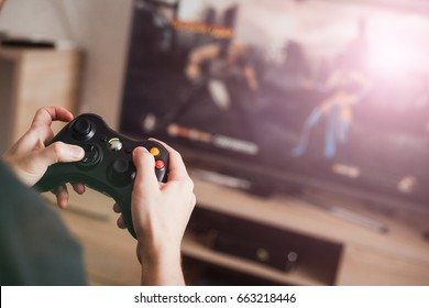 The guy is playing on the console - Shutterstock ID 663218446