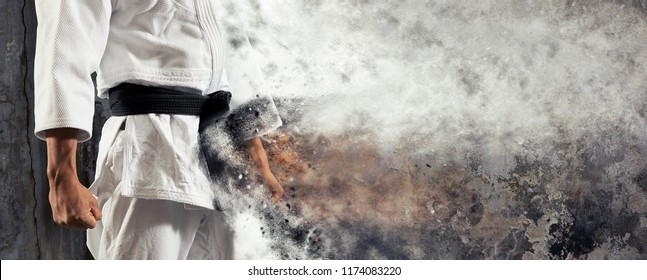 Guy poses in white kimono with black belt.  Japanese judo banner - Powered by Shutterstock