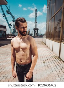 A guy are posing in the port on the camera