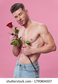 A Guy With A Pumped-up Torso Holds A Red Flower In His Hand