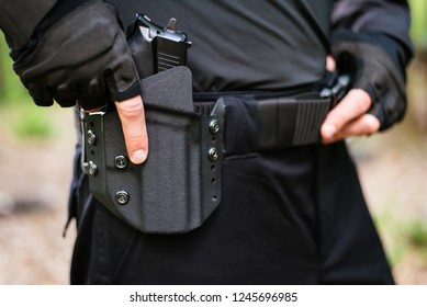 the guy puts the gun in the holster