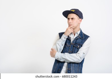 Guy In A Rapper Cap Is Thinking About Something. He Looks Cool And Fashionable.